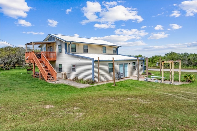 rear view of property with central AC, a patio area, a lawn, and a wooden deck