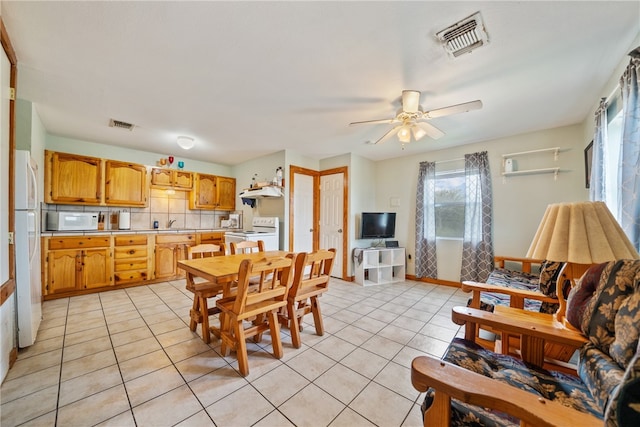 tiled dining space with ceiling fan