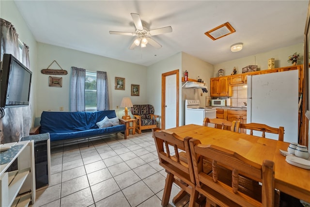 dining area with light tile patterned flooring and ceiling fan