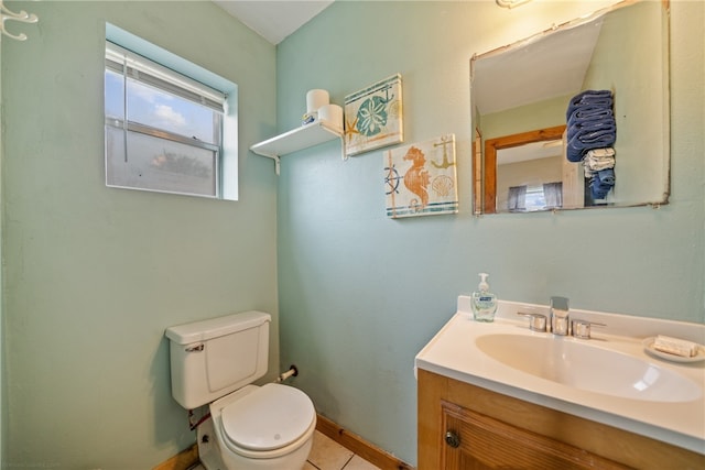 bathroom featuring vanity, tile patterned flooring, and toilet