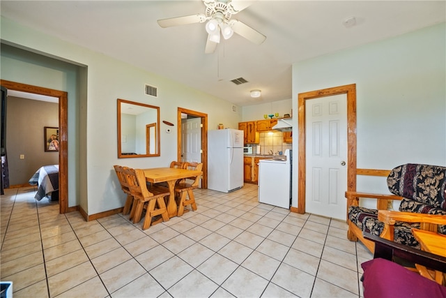 kitchen featuring white appliances, ceiling fan, light tile patterned floors, and tasteful backsplash