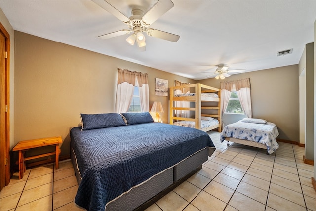 tiled bedroom featuring ceiling fan