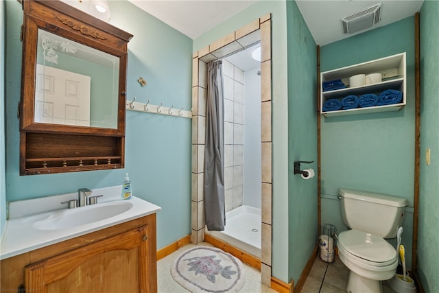 bathroom featuring walk in shower, vanity, toilet, and tile patterned flooring