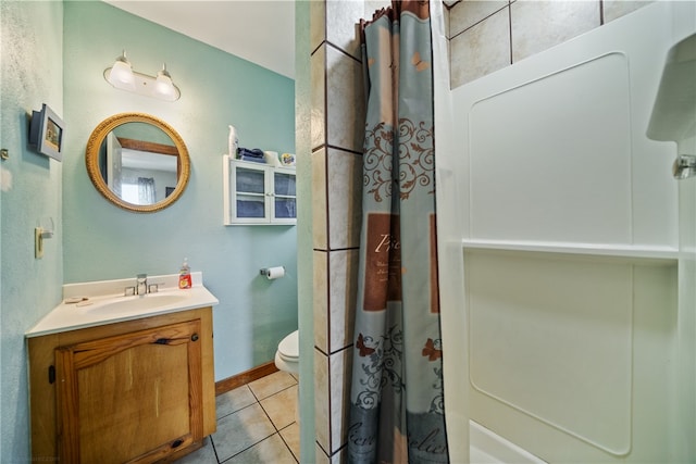 bathroom featuring toilet, vanity, tile patterned floors, and a shower with curtain