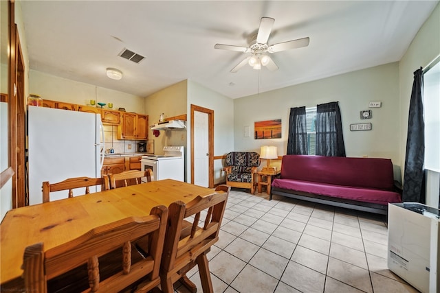 tiled dining room featuring ceiling fan