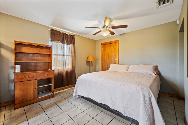 tiled bedroom featuring ceiling fan