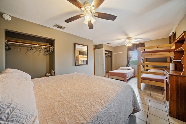 tiled bedroom with a closet and ceiling fan