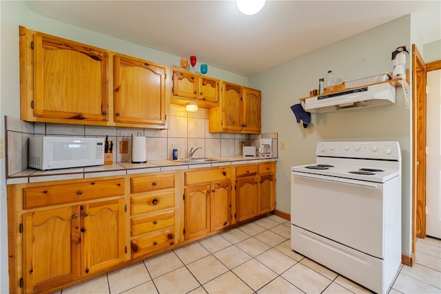 kitchen with tile countertops, tasteful backsplash, light tile patterned floors, white appliances, and exhaust hood