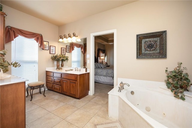 bathroom with tile patterned flooring, vanity, and a tub