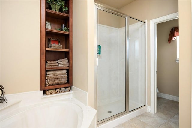 bathroom with tile patterned floors and independent shower and bath