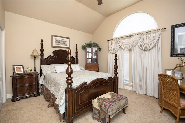 bedroom with ceiling fan, light colored carpet, lofted ceiling, and multiple windows