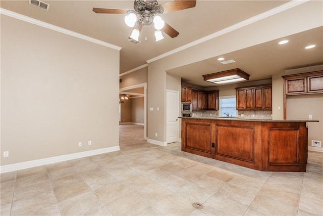 7510 Beau Terre, Corpus Christi, TX 78414 - kitchen featuring stainless steel microwave, a ceiling fan, ornamental molding, a sink, and baseboards