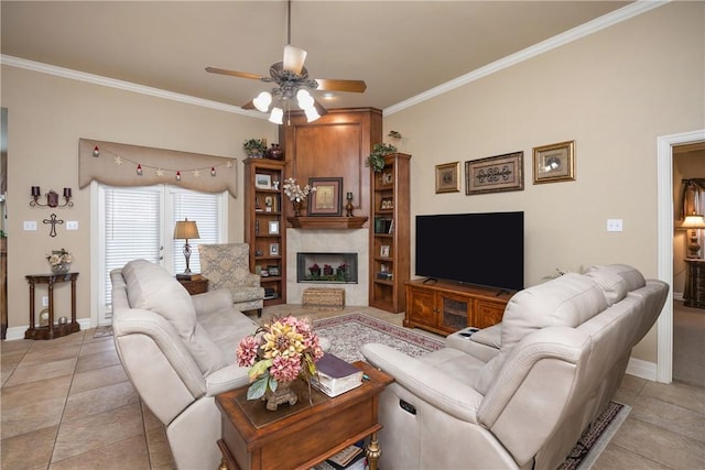 living room featuring a fireplace, light tile patterned floors, ceiling fan, and ornamental molding