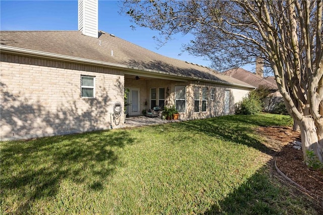 7510 Beau Terre, Corpus Christi, TX 78414 - back of property with a lawn, a chimney, brick siding, a patio area, and roof with shingles
