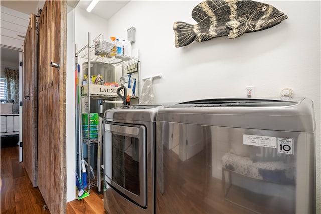 laundry area featuring washer and dryer and wood-type flooring