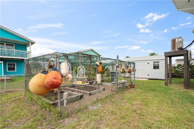 view of yard with central AC unit and a storage unit