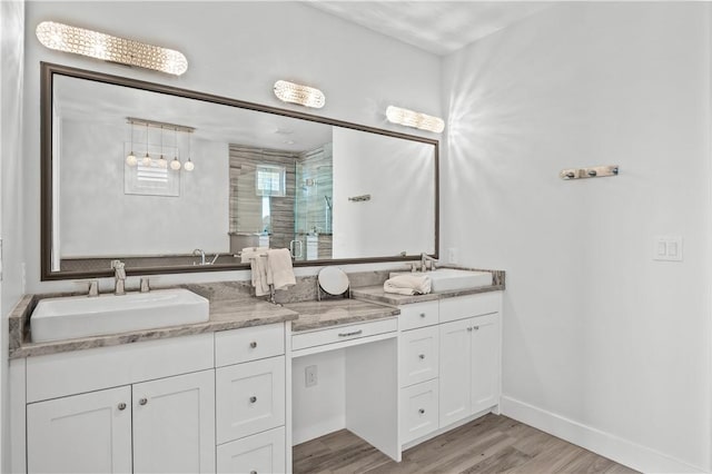 144 Sunrise Ave, Port Aransas, TX 78373 - full bath with double vanity, wood finished floors, a stall shower, and baseboards