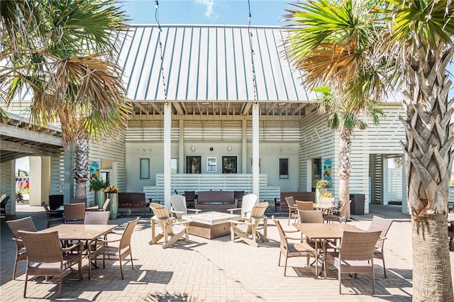 144 Sunrise Ave, Port Aransas, TX 78373 - view of patio with outdoor dining area and an outdoor living space with a fire pit
