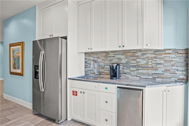 144 Sunrise Ave, Port Aransas, TX 78373 - kitchen featuring stainless steel refrigerator with ice dispenser, fridge, a sink, backsplash, and light stone countertops