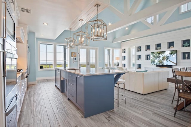 144 Sunrise Ave, Port Aransas, TX 78373 - kitchen with a sink, a chandelier, a breakfast bar area, open floor plan, and recessed lighting