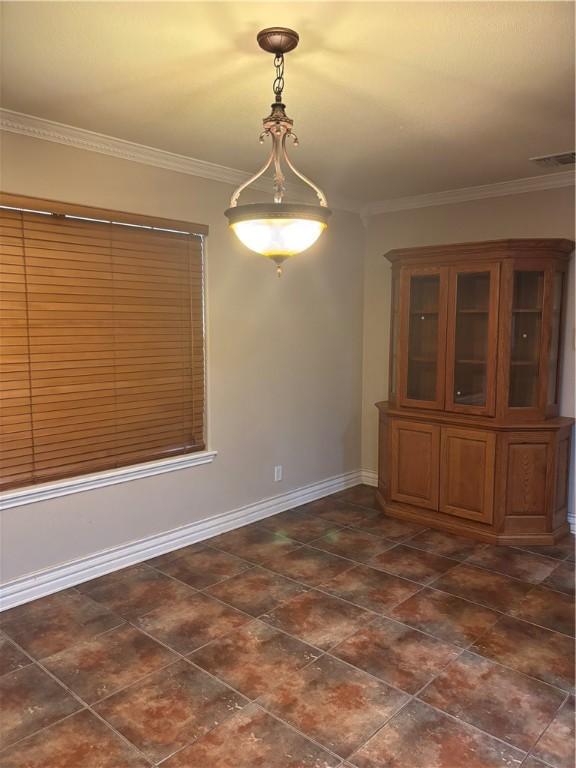 unfurnished dining area featuring ornamental molding