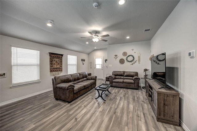 living room featuring vaulted ceiling, ceiling fan, and wood-type flooring