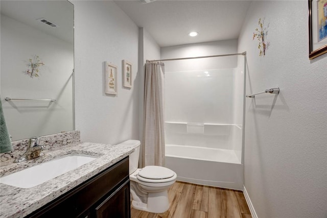 full bathroom with shower / bathtub combination with curtain, toilet, vanity, and hardwood / wood-style flooring