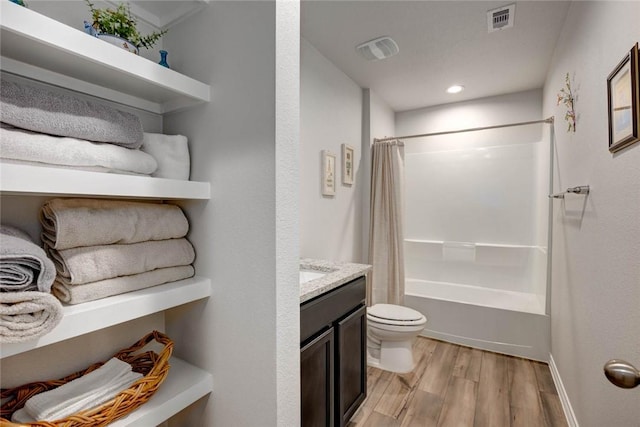 full bathroom featuring toilet, shower / bath combo with shower curtain, wood-type flooring, and vanity