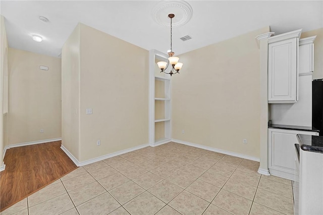 126 Whistlers Cove Rd, Rockport, TX 78382 - unfurnished dining area featuring a chandelier, light tile patterned floors, and baseboards