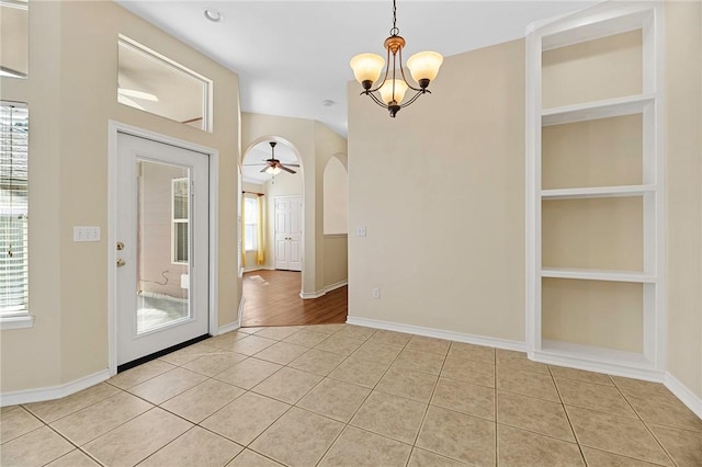 126 Whistlers Cove Rd, Rockport, TX 78382 - unfurnished dining area with plenty of natural light, light tile patterned floors, arched walkways, and a chandelier