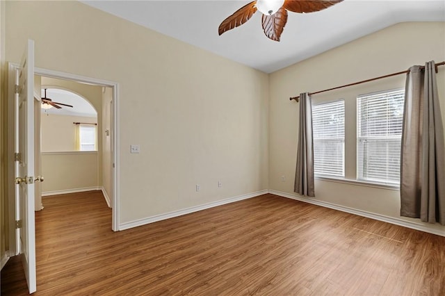 126 Whistlers Cove Rd, Rockport, TX 78382 - empty room with a ceiling fan, wood finished floors, baseboards, and arched walkways