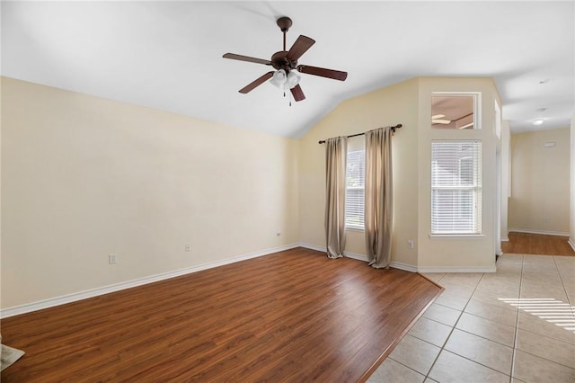 126 Whistlers Cove Rd, Rockport, TX 78382 - unfurnished room with a ceiling fan, vaulted ceiling, baseboards, and wood finished floors