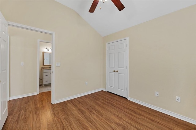 126 Whistlers Cove Rd, Rockport, TX 78382 - unfurnished bedroom featuring lofted ceiling, wood finished floors, baseboards, a closet, and ceiling fan