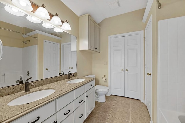 126 Whistlers Cove Rd, Rockport, TX 78382 - bathroom featuring a closet, double vanity, tile patterned floors, and toilet
