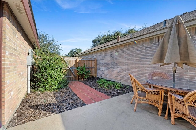 126 Whistlers Cove Rd, Rockport, TX 78382 - view of patio with outdoor dining space and a gate