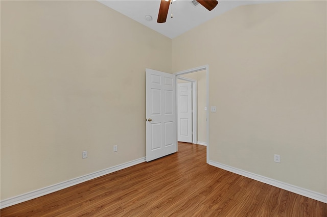 empty room featuring ceiling fan, light hardwood / wood-style floors, and high vaulted ceiling