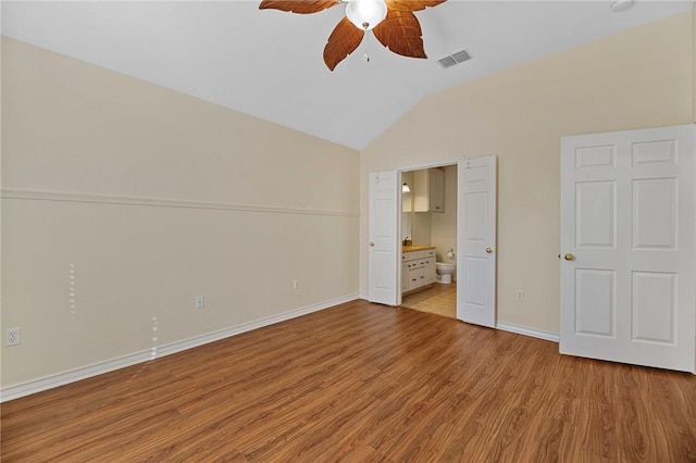 126 Whistlers Cove Rd, Rockport, TX 78382 - unfurnished bedroom featuring vaulted ceiling, light wood-type flooring, ensuite bathroom, baseboards, and ceiling fan