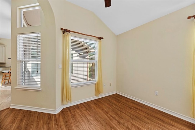 126 Whistlers Cove Rd, Rockport, TX 78382 - spare room featuring wood finished floors, lofted ceiling, a ceiling fan, baseboards, and arched walkways