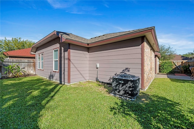 exterior space featuring a lawn and cooling unit