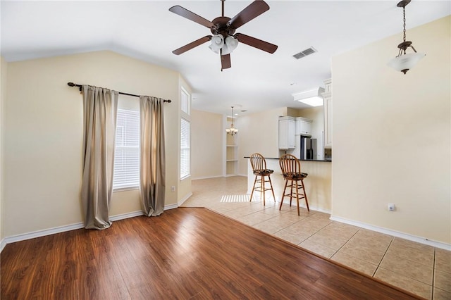 126 Whistlers Cove Rd, Rockport, TX 78382 - living area with a ceiling fan, light wood-style flooring, baseboards, and vaulted ceiling