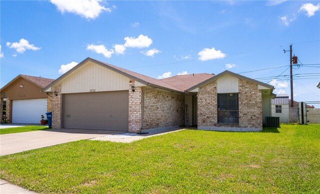 2722 Camargo Dr, Corpus Christi, TX 78415 - view of front facade featuring a garage, concrete driveway, and brick siding