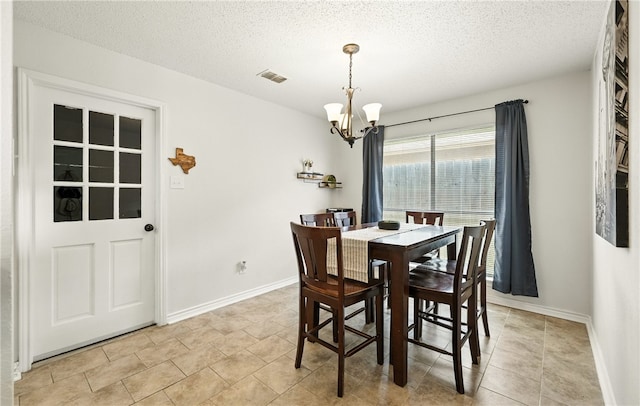 2722 Camargo Dr, Corpus Christi, TX 78415 - dining room featuring a chandelier and a textured ceiling