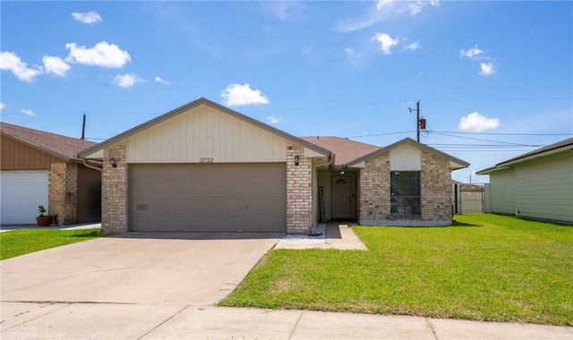 2722 Camargo Dr, Corpus Christi, TX 78415 - view of front of home featuring an attached garage, concrete driveway, a front yard, and brick siding