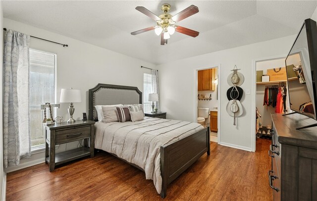 2722 Camargo Dr, Corpus Christi, TX 78415 - bedroom with dark wood-type flooring, a walk in closet, ceiling fan, and a closet