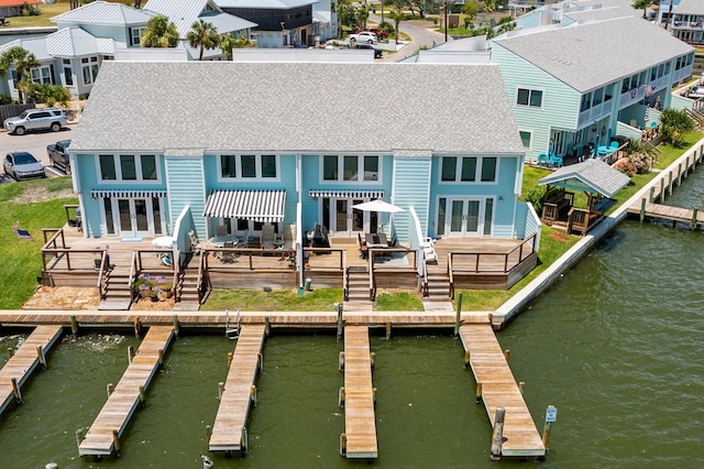 rear view of house featuring a patio area and a deck with water view