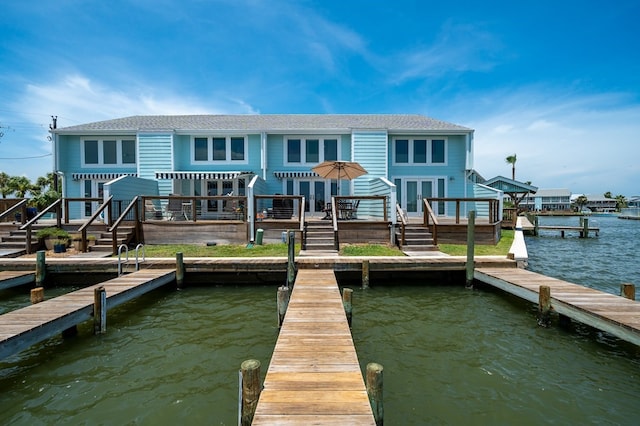 back of house with a deck with water view