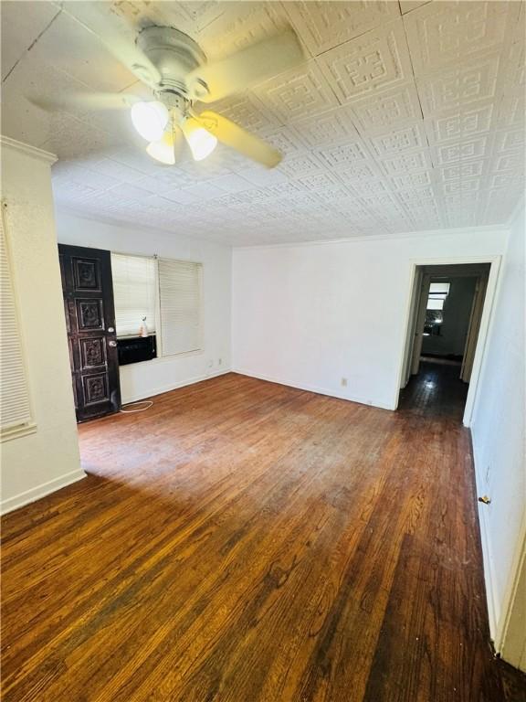 1725 Sycamore Pl, Corpus Christi, TX 78416 - unfurnished living room with wood finished floors, a ceiling fan, and baseboards