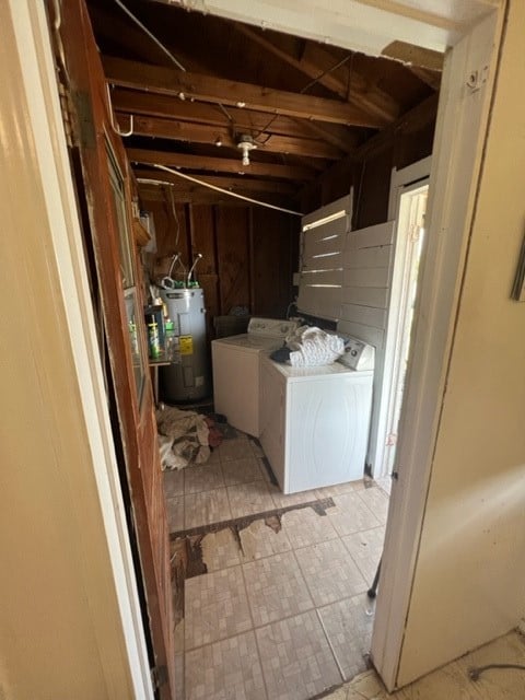 washroom with electric water heater and washer and clothes dryer