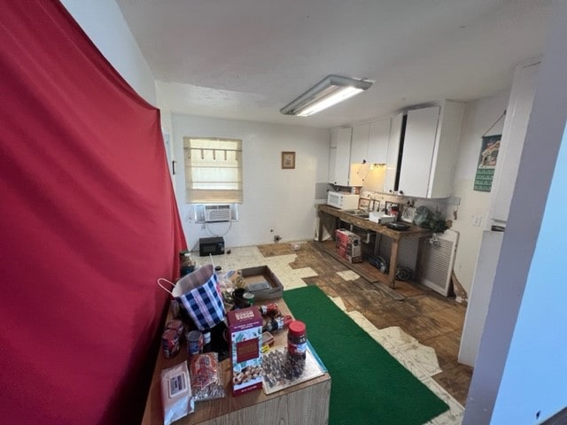 kitchen with white cabinetry and cooling unit