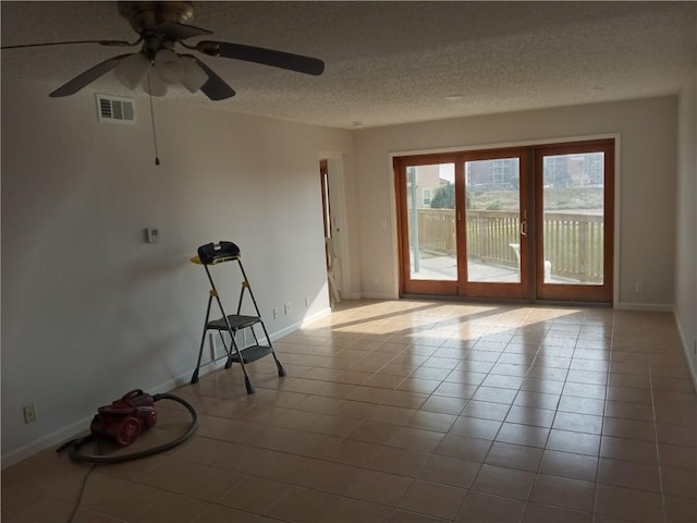 5973 State Highway 361 Unit 121, Port Aransas, TX 78373 - unfurnished room with baseboards, a ceiling fan, a textured ceiling, and tile patterned floors